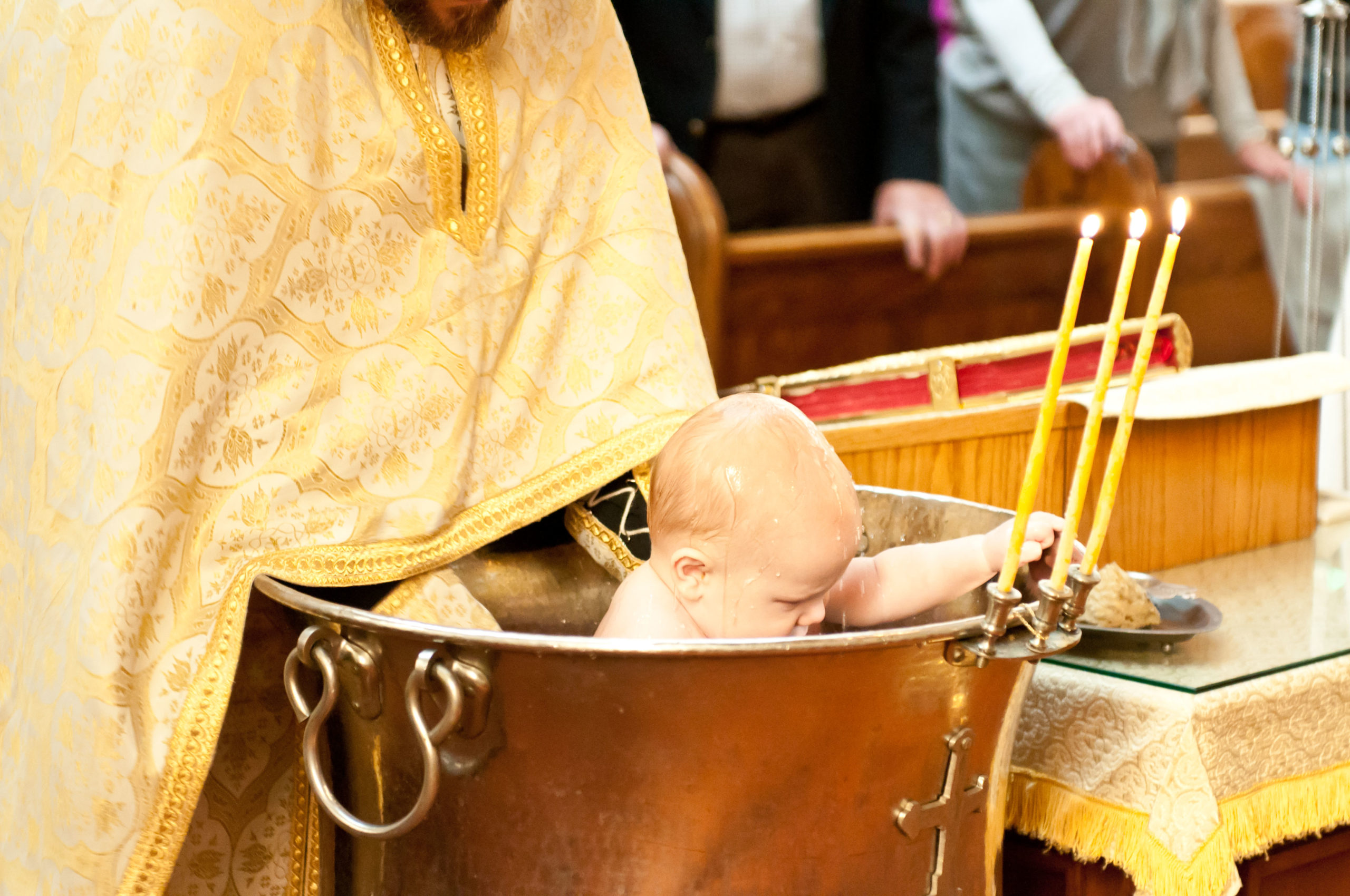 Priest baptizing Roman at St Mary's Orthodox Cathedral