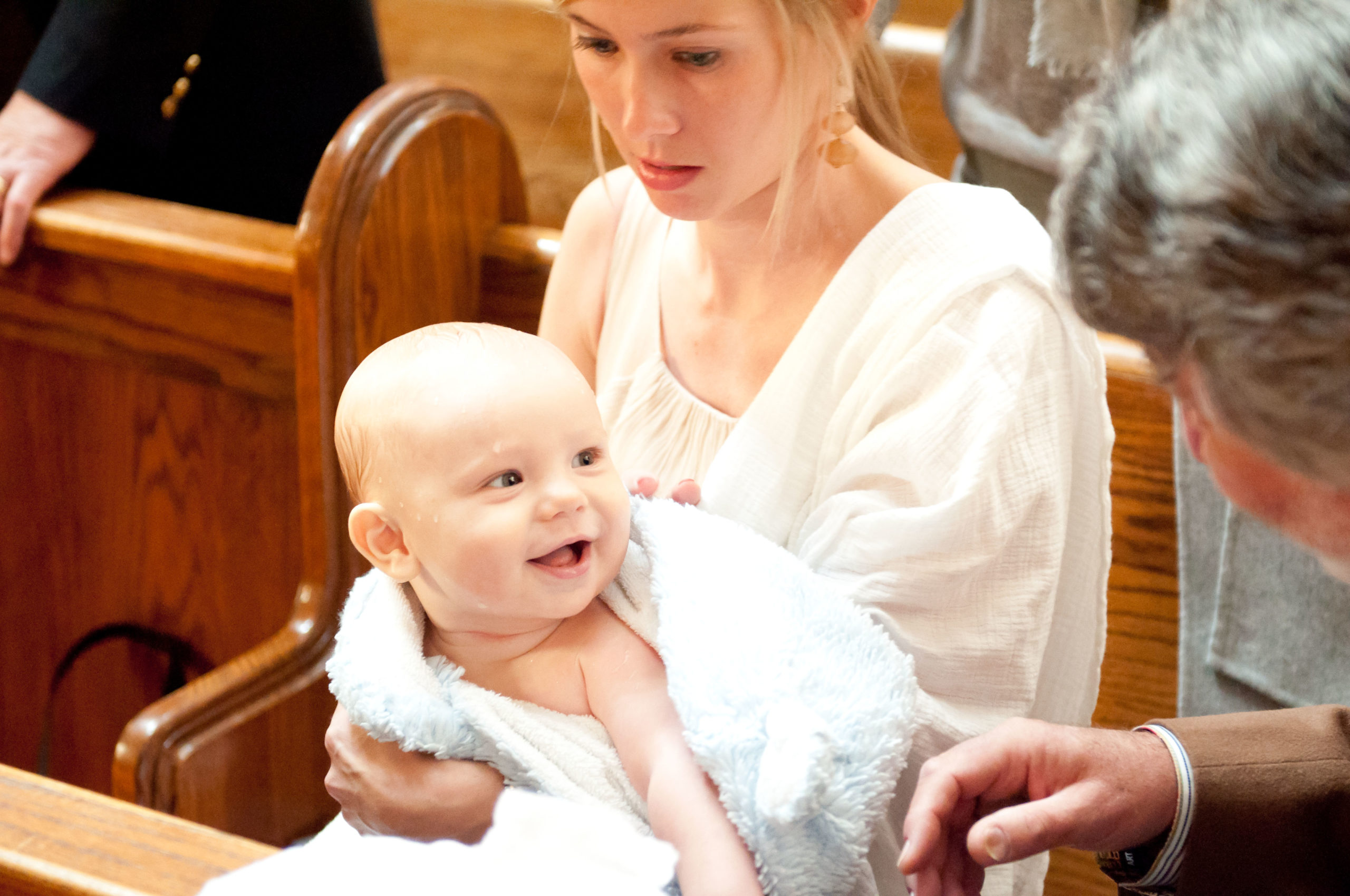 Mom holding baby after baptized