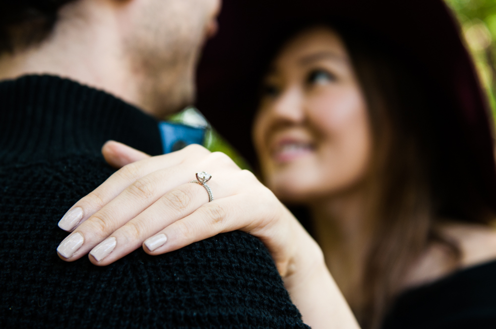 couple hugging with engagement rings