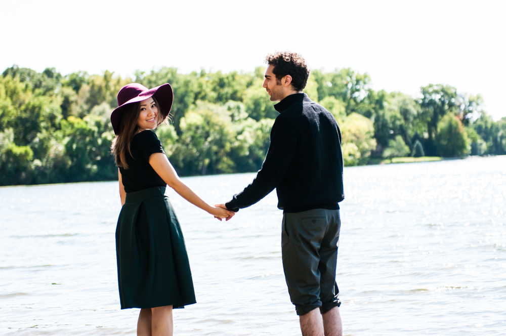 Couple holding hands in lake in Minneapolis