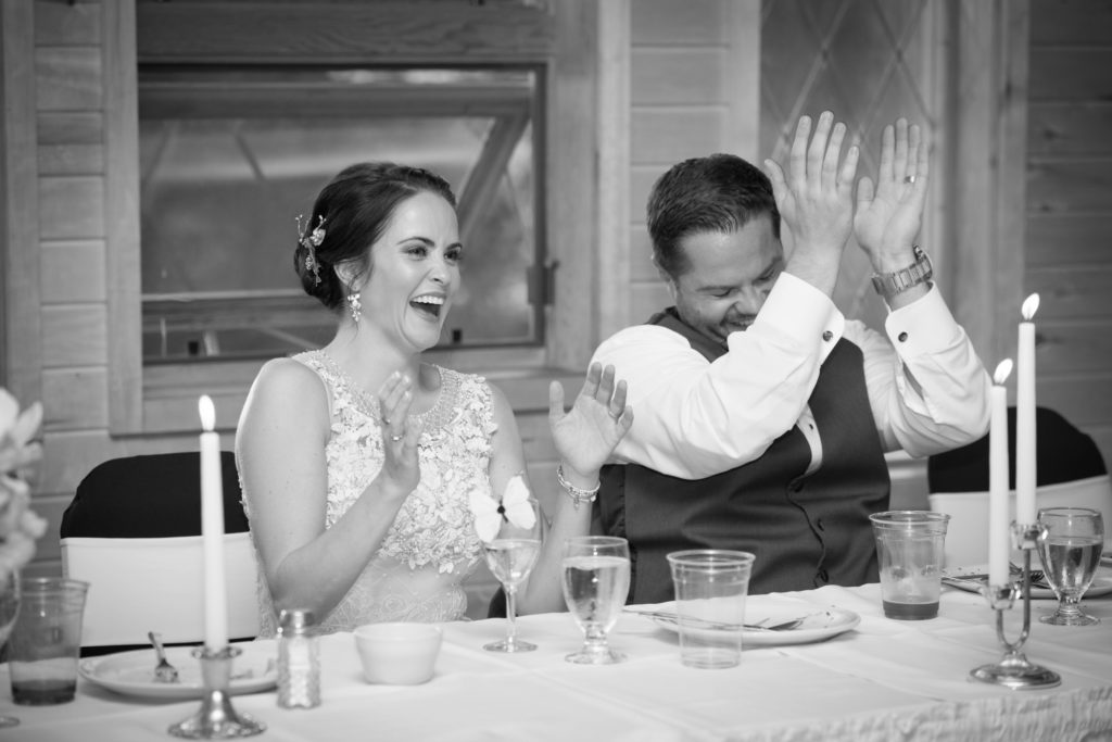 Couple clapping at wedding speeches in Minnesota
