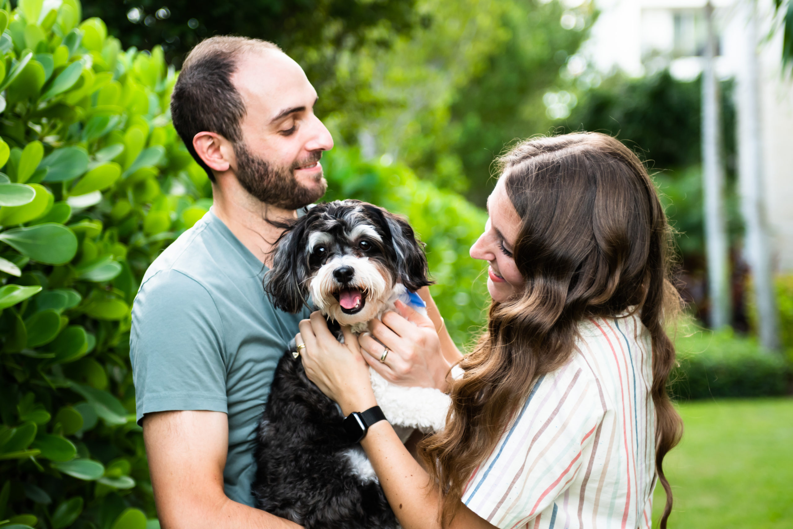 Couple smiling with dog in Fort Lauderdale