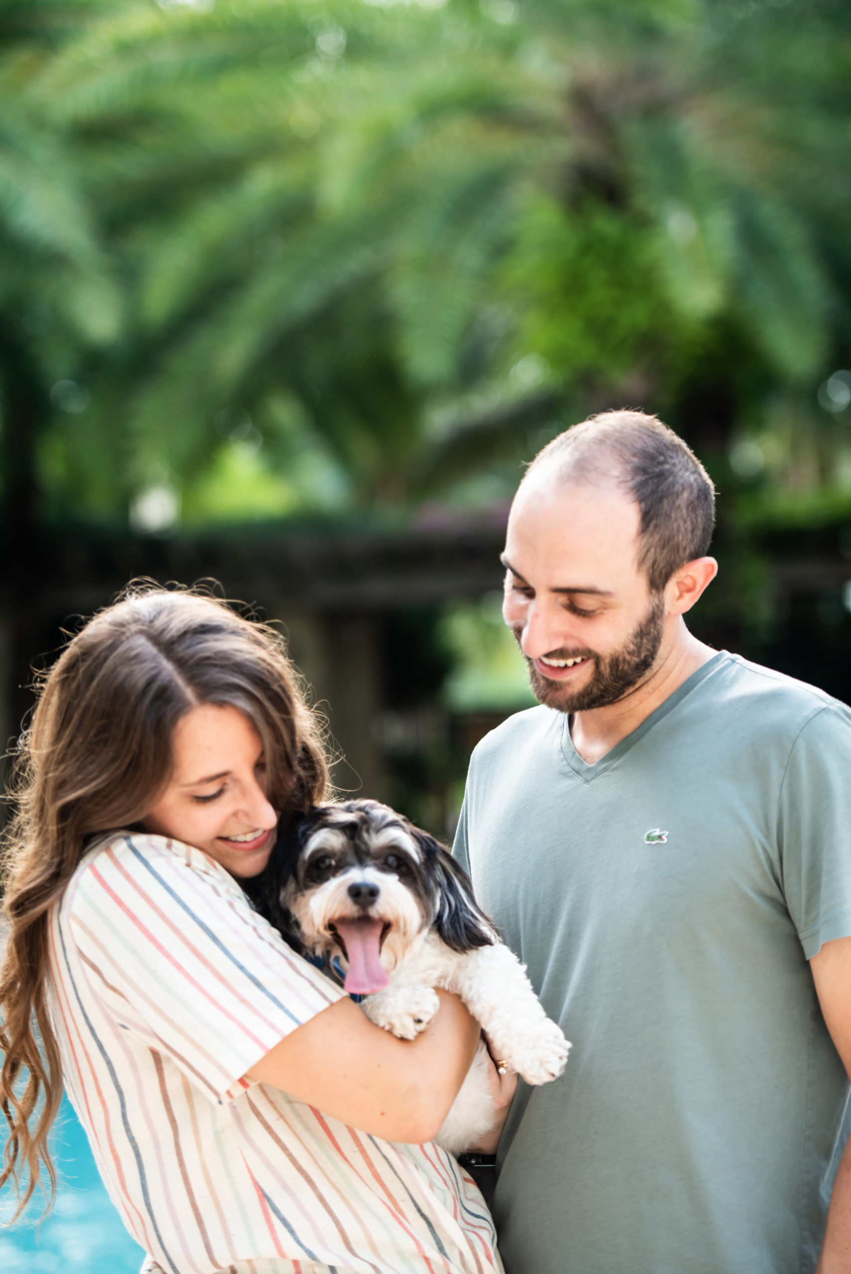 Couple holding dog during engagement session in Florida