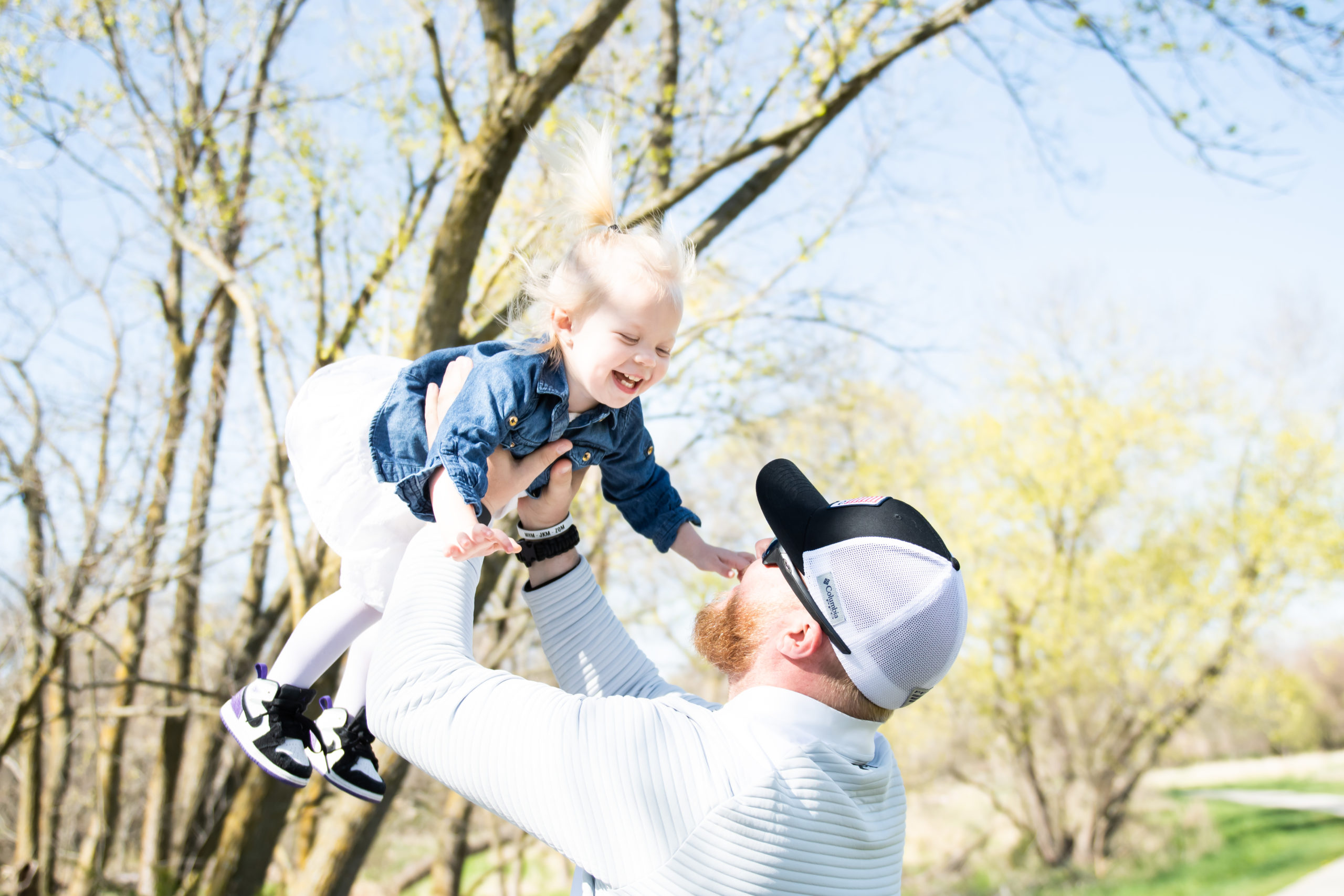 Dad throwing daughter in air at Nebraska park