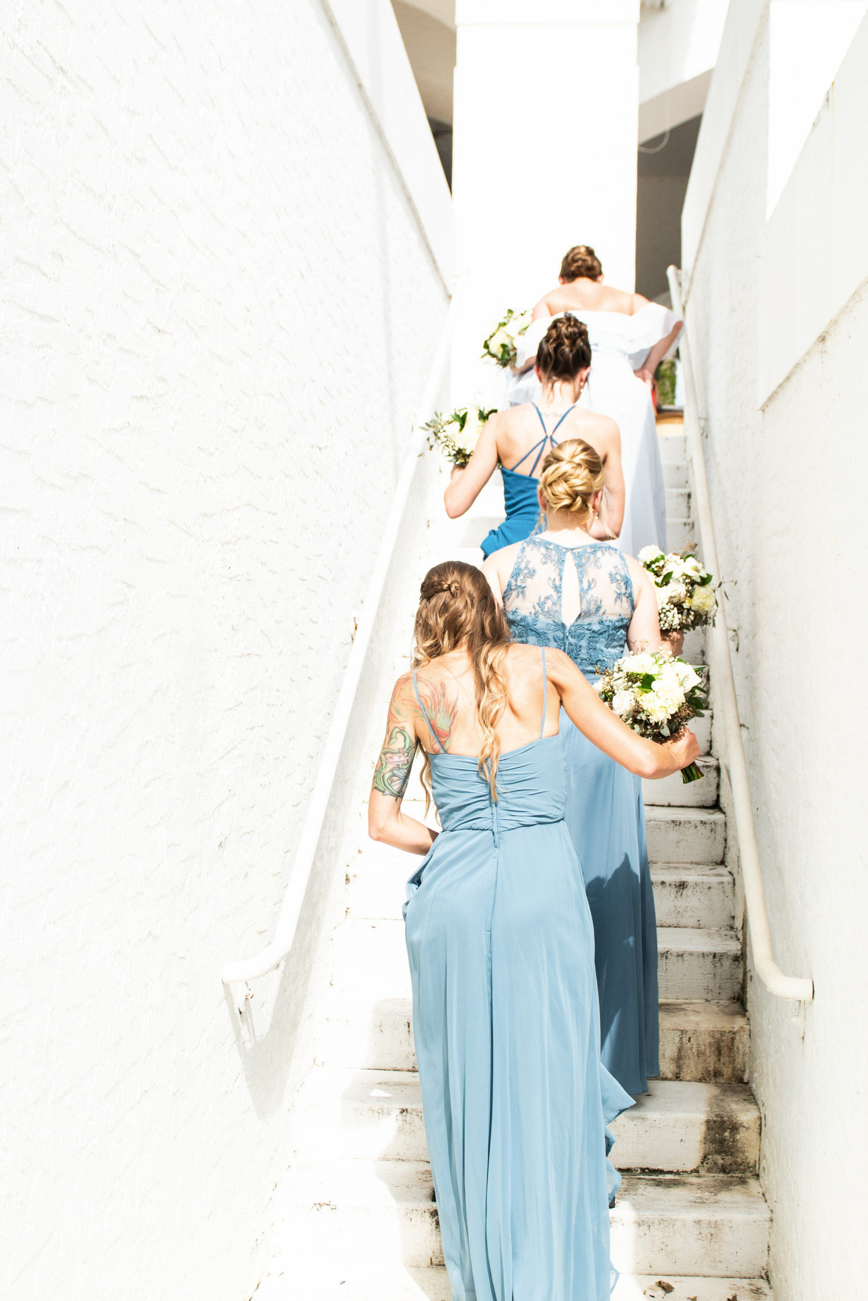 Bridesmaids walking up the stairs