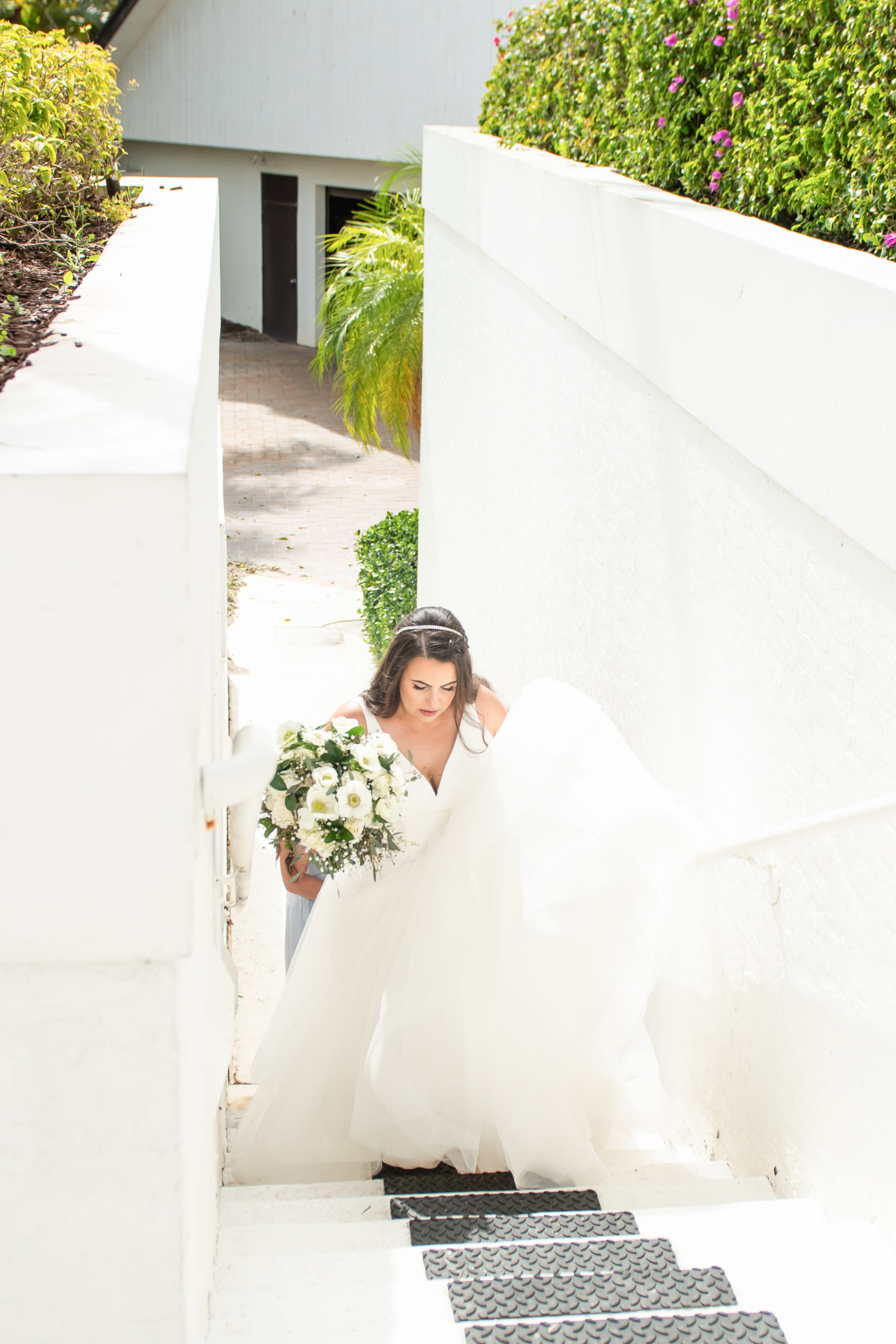 Bride walking up staircase