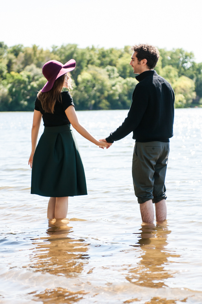 Couple standing in water looking at each other 