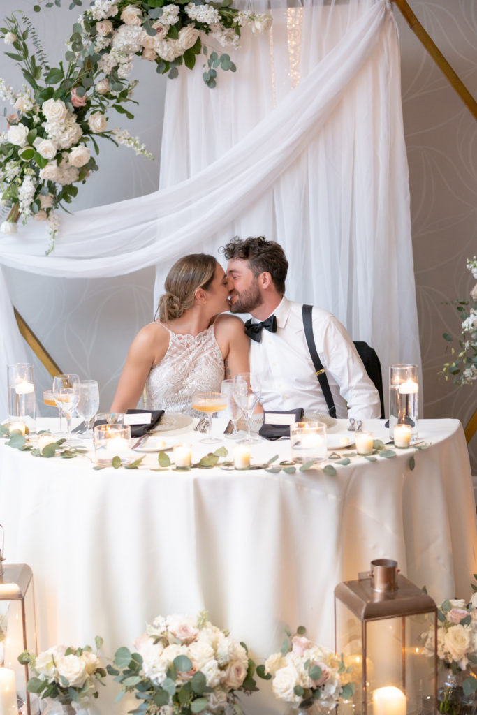 Bride and groom kissing at wedding reception at Wyndham Grand Jupiter 