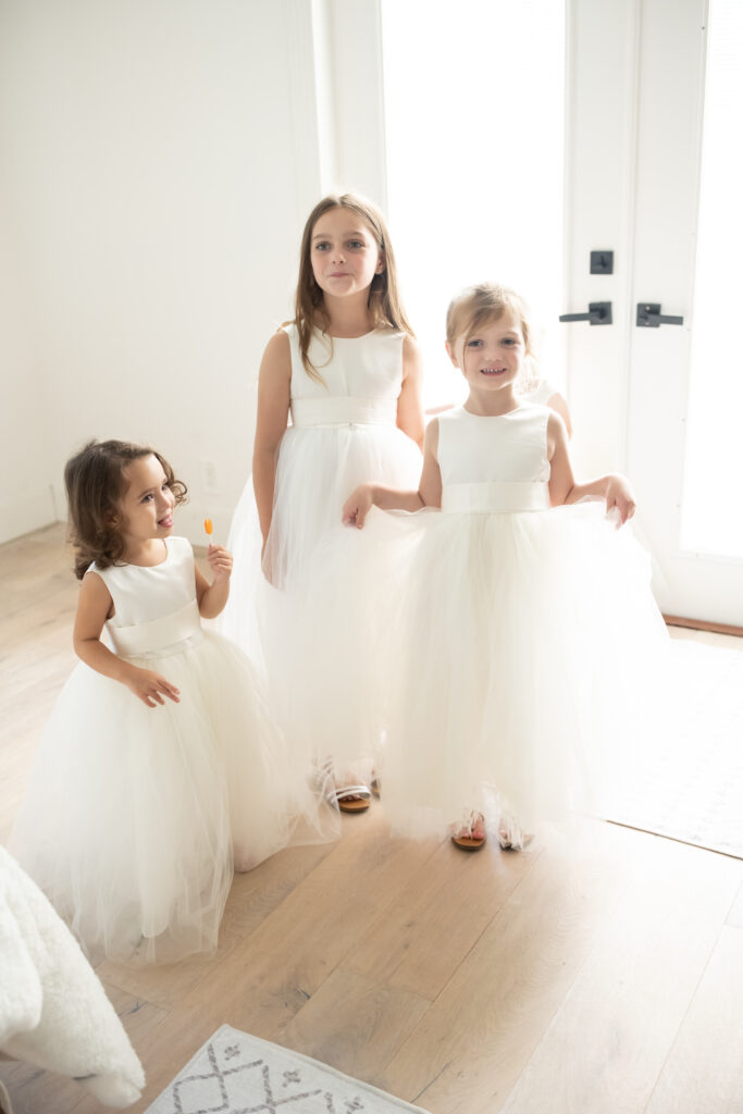 Flower girls playing in dresses on wedding day 