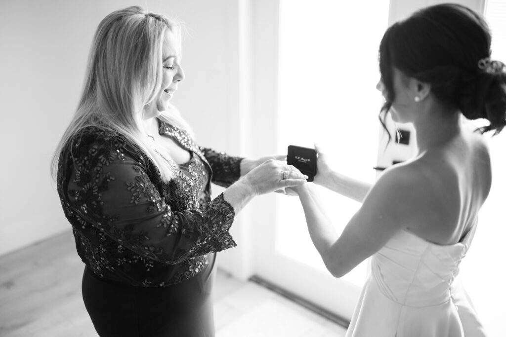 Bride gifting mother with jewelry on morning of her wedding day 