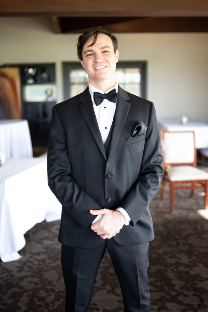 Groom posing for camera in Tuxedo 