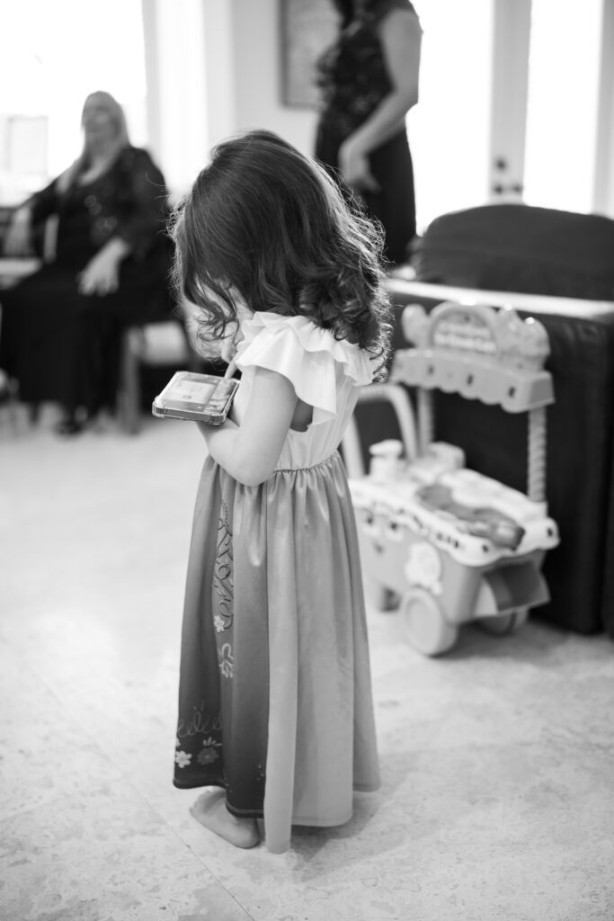 Daughter of bride playing game in princess dress
