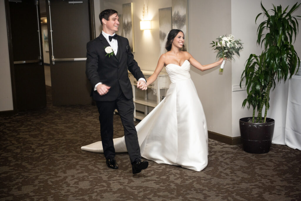 Bride and groom entering wedding reception at Eastpointe Country Club 