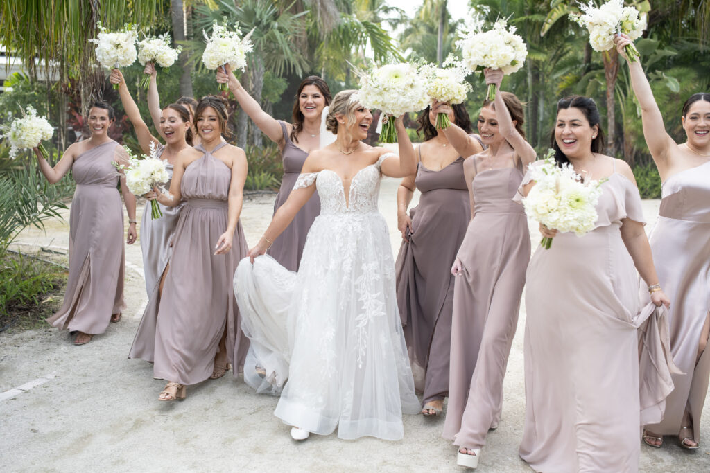 Bride holding up bouquet with bridesmaids at Islamorada Wedding 