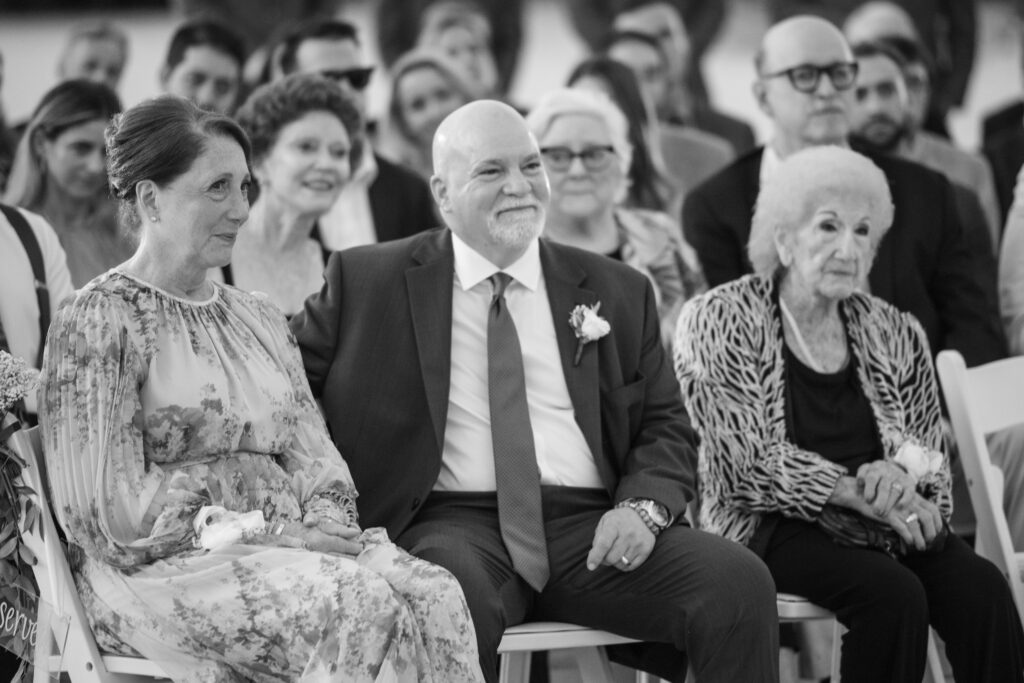 Parents of groom smiling at son during florida keys wedding ceremony 