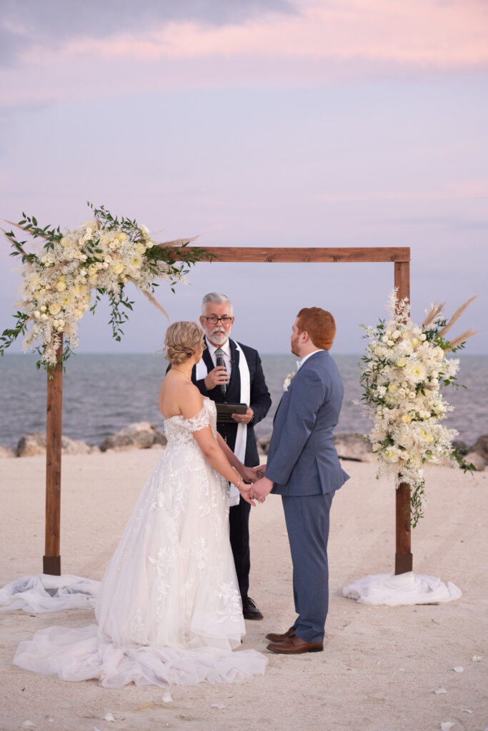 Bride and groom looking at officiant at Florida keys wedding 