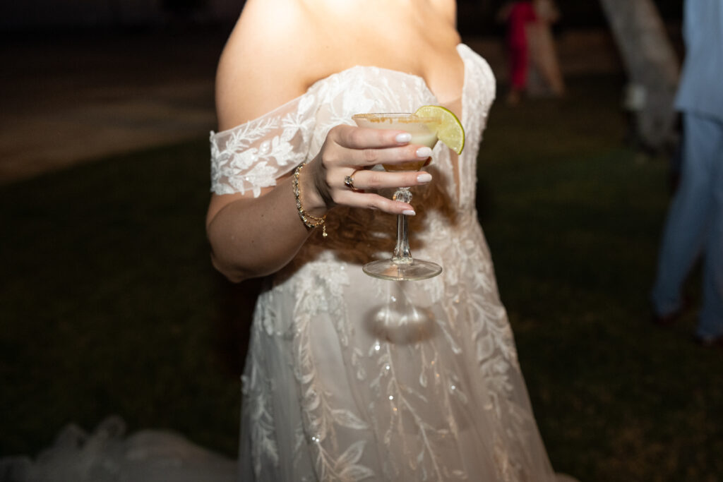 Bride holding martini in wedding dress on Islamorada beach in Florida 